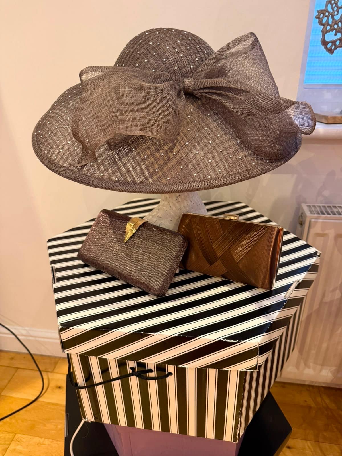 Taupe wide-brim hat with crystal dots and oversized bow, with two bronze occasion clutches